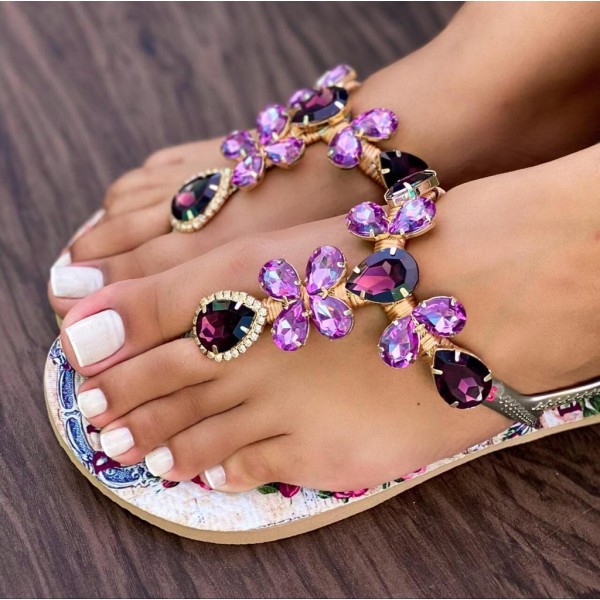 White women slippers decorated with flowers and decorated with violet stones