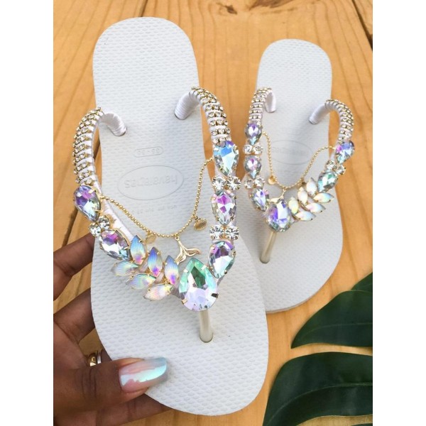 White slippers for women decorated with stones and metal