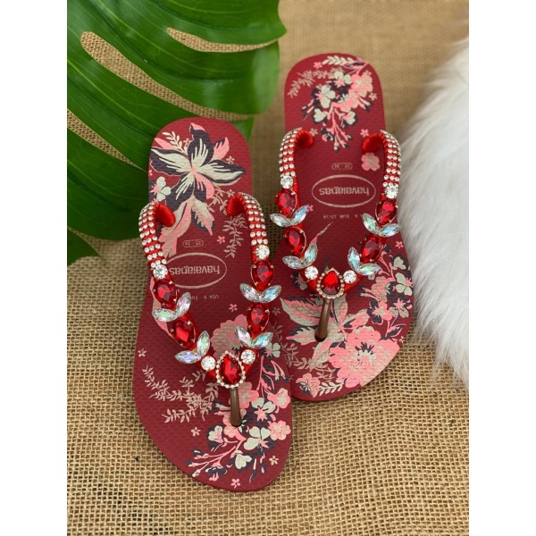 Red women slippers decorated with flowers and stones